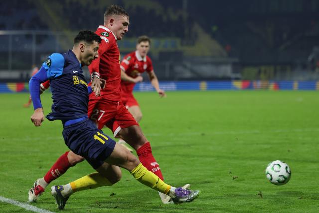 (251219) -- CELJE, Dec. 19, 2025 (Xinhua) -- Milot Avdyli (L) of NK Celje passes the ball during the UEFA Conference League match between NK Celje and Shelbourne FC in Celje, Slovenia, Dec. 18, 2025. (Photo by Zeljko Stevanic/Xinhua)