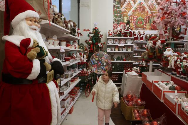 (251219) -- NAZARETH, Dec. 19, 2025 (Xinhua) -- A girl views Christmas decorations at a store in the northern Israeli city of Nazareth on Dec. 18, 2025.
  The Christmas celebrations came amid a fragile ceasefire between Israel and Hamas following two years of conflict in the Gaza Strip. Scenes of holiday activities highlighted moments of relative calm and a desire for normalcy among local communities during the Christmas season. (Photo by Gil Cohen Magen/Xinhua)