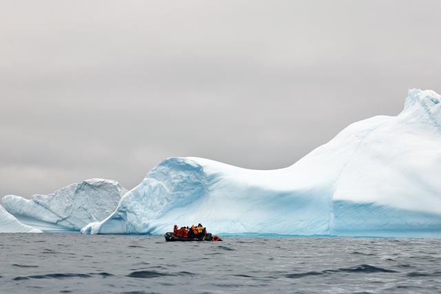 (251219) -- ANTARCTICA, Dec. 19, 2025 (Xinhua) -- People take photos of an iceberg near the coast of Spert Island in Antarctica, Dec. 16, 2025. (Photo by Yang Shu/Xinhua)