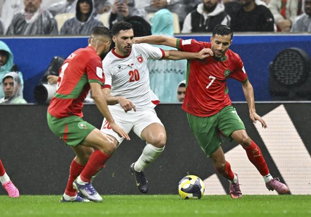 (251219) -- LUSAIL, Dec. 19, 2025 (Xinhua) -- Mohamed Boulacsout (R) of Morocco vies with Mohannad Abutaha (C) of Jordan during the FIFA Arab Cup 2025 final match between Jordan and Morocco at Lusail Stadium in Lusail, Qatar, on Dec. 18, 2025. (Photo by Nikku/Xinhua)