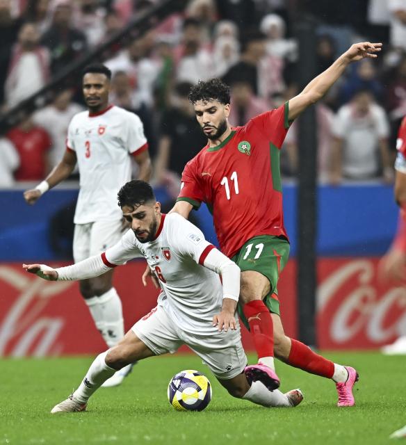 (251219) -- LUSAIL, Dec. 19, 2025 (Xinhua) -- Oualid Azaro (R) of Morocco vies with Amer Jamous (L) of Jordan during the FIFA Arab Cup 2025 final match between Jordan and Morocco at Lusail Stadium in Lusail, Qatar, on Dec. 18, 2025. (Photo by Nikku/Xinhua)