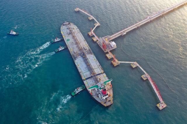 (251219) -- BEIJING, Dec. 19, 2025 (Xinhua) -- An aerial drone photo shows a vessel carrying 179,000 tonnes of petrochemical raw materials berthing at Yangpu Port in Danzhou, south China's Hainan Province, Dec. 18, 2025. China on Thursday launched island-wide special customs operations in the Hainan Free Trade Port (FTP).
   A vessel carrying petrochemical raw materials arrived at Yangpu Port in the morning, marking the first batch of zero-tariff petrochemical raw materials to undergo special customs clearance there after the launch of the special customs operations. (Xinhua/Guo Cheng)