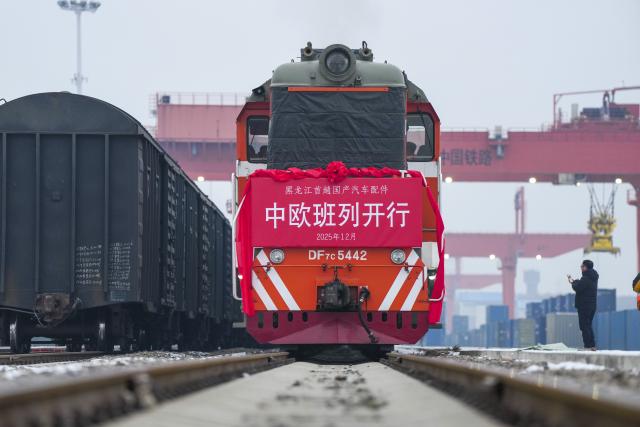(251219) -- BEIJING, Dec. 19, 2025 (Xinhua) -- A China-Europe freight train loaded with containers of domestic auto parts is pictured at Harbin international container center station in Harbin, northeast China's Heilongjiang Province, Dec. 18, 2025. (Xinhua/Wang Song)