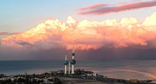 (251219) -- BEIJING, Dec. 19, 2025 (Xinhua) -- A drone photo taken on Dec. 17, 2025 shows a city view with clouds rolling over Kuwait City, Kuwait. (Photo by Asad/Xinhua)