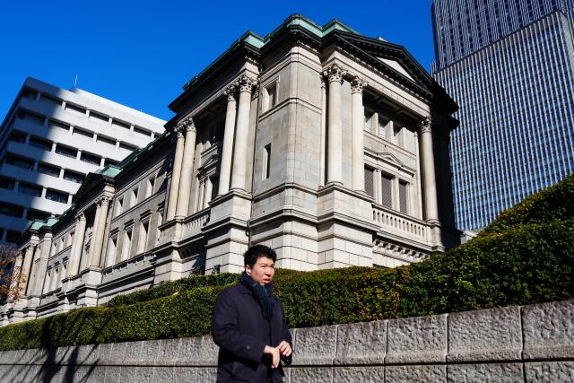 (251219) -- TOKYO, Dec. 19, 2025 (Xinhua) -- A pedestrian walks past the headquarters of Bank of Japan (BOJ) in Tokyo, Japan, Dec. 18, 2025.
  The Bank of Japan (BOJ) on Friday raised its benchmark interest rate by 25 basis points to 0.75 percent, its highest level in three decades, after a two-day monetary policy meeting. (Xinhua/Jia Haocheng)