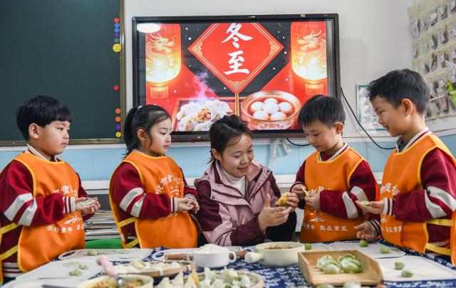 (251219) -- BEIJING, Dec. 19, 2025 (Xinhua) -- A teacher teaches children to make dumplings at a kindergarten in Zunhua City, north China's Hebei Province, Dec. 19, 2025. Winter Solstice, the shortest day of the year, which will fall on Dec. 21 this year, denotes the beginning of deep winter and a break from farming in traditional agricultural society in Chinese culture. 
   Northern China has maintained the tradition of eating dumplings on this day, while people in southern China eat tangyuan (glutinous rice balls). (Photo by Liu Mancang/Xinhua)