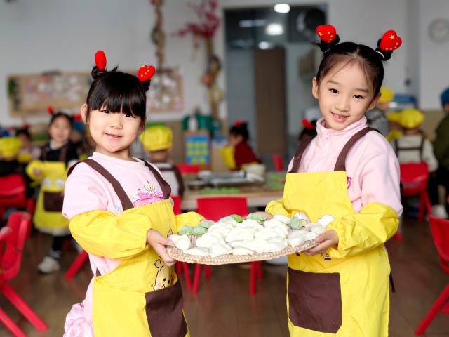 (251219) -- BEIJING, Dec. 19, 2025 (Xinhua) -- Children present the dumplings they made at a kindergarten in Jiyuan City, east China's Shandong Province, Dec. 19, 2025. Winter Solstice, the shortest day of the year, which will fall on Dec. 21 this year, denotes the beginning of deep winter and a break from farming in traditional agricultural society in Chinese culture. 
   Northern China has maintained the tradition of eating dumplings on this day, while people in southern China eat tangyuan (glutinous rice balls). (Photo by Duan Erping/Xinhua)