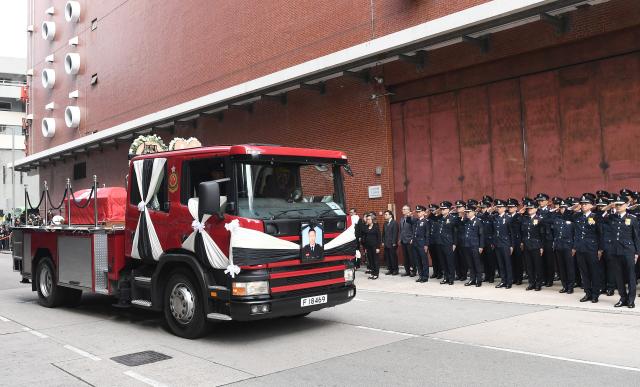 (251219) -- HONG KONG, Dec. 19, 2025 (Xinhua) -- A hearse converted from a fire engine leaves the Universal Funeral Parlour in Hung Hom, Kowloon, south China's Hong Kong, Dec. 19, 2025. The Fire Services Department (FSD) of the Hong Kong Special Administrative Region (HKSAR) government on Friday held an official funeral service with full honors for the late firefighter Ho Wai-ho, who sacrificed his life battling a major blaze in Tai Po. John Lee, chief executive of the HKSAR and a host of senior HKSAR government officials attended the ceremony to pay their respects.
   TO GO WITH "Funeral with full honors held in Hong Kong for late firefighter Ho Wai-ho" (Xinhua/Chen Duo)