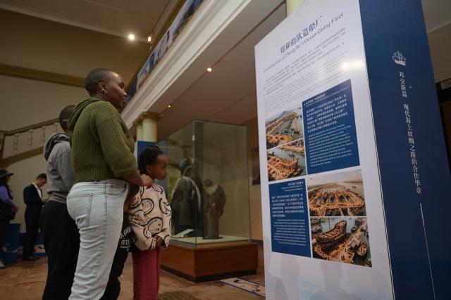 (251219) -- NAIROBI, Dec. 19, 2025 (Xinhua) -- People visit a photo exhibition commemorating the 620th Anniversary of Zheng He's Voyages and the 62nd anniversary of the establishment of China-Kenya diplomatic relations, in Nairobi, Kenya, Dec. 19, 2025. TO GO WITH "Kenya holds photo exhibition to mark 620th anniversary of Zheng He's voyages" (Xinhua/Yang Guang)
