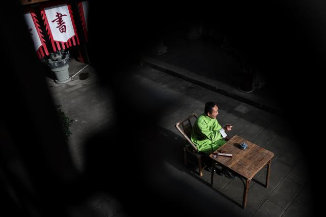 (251219) -- GUANGYUAN, Dec. 19, 2025 (Xinhua) -- Gou Huan, an inheritor of the intangible cultural heritage of traditional Chinese storytelling, performs in Zhaohua ancient town in Zhaohua District of Guangyuan City, southwest China's Sichuan Province, Dec. 13, 2025. Zhaohua ancient town, located in Guangyuan City of southwest China's Sichuan Province, sits at the confluence of the Bailong River, the Jialing River, and the Qingjiang River. As a well-preserved ancient town, it carries a history of over 2,300 years.
    However, due to old infrastructure and unplanned construction, the ancient town once fell into disorder with residents living in the town having to undergo various difficulties. In order to refresh the ancient town, since 2012, Zhaohua District has launched a project to preserve the villages as a whole. While improving the village environment, the preservation project brings along local rural tourism, allowing the ancient town to be revitalized through preservation. (Xinhua/Pan Yulong)
