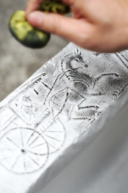 (251219) -- GUANGYUAN, Dec. 19, 2025 (Xinhua) -- Rao Bin, a collector of bricks of Han Dynasty (202 B.C.-220 A.D.), makes rubbings of a brick at his home in Zhaohua ancient town in Zhaohua District of Guangyuan City, southwest China's Sichuan Province, Dec. 13, 2025. Zhaohua ancient town, located in Guangyuan City of southwest China's Sichuan Province, sits at the confluence of the Bailong River, the Jialing River, and the Qingjiang River. As a well-preserved ancient town, it carries a history of over 2,300 years.
    However, due to old infrastructure and unplanned construction, the ancient town once fell into disorder with residents living in the town having to undergo various difficulties. In order to refresh the ancient town, since 2012, Zhaohua District has launched a project to preserve the villages as a whole. While improving the village environment, the preservation project brings along local rural tourism, allowing the ancient town to be revitalized through preservation. (Xinhua/Chen Bin)