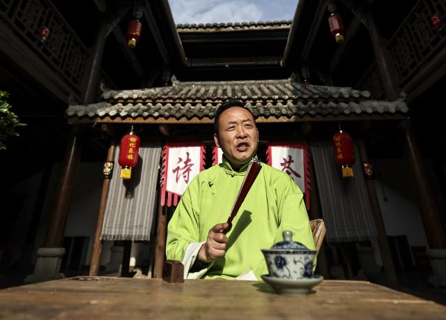 (251219) -- GUANGYUAN, Dec. 19, 2025 (Xinhua) -- Gou Huan, an inheritor of the intangible cultural heritage of traditional Chinese storytelling, performs in Zhaohua ancient town in Zhaohua District of Guangyuan City, southwest China's Sichuan Province, Dec. 13, 2025. Zhaohua ancient town, located in Guangyuan City of southwest China's Sichuan Province, sits at the confluence of the Bailong River, the Jialing River, and the Qingjiang River. As a well-preserved ancient town, it carries a history of over 2,300 years.
    However, due to old infrastructure and unplanned construction, the ancient town once fell into disorder with residents living in the town having to undergo various difficulties. In order to refresh the ancient town, since 2012, Zhaohua District has launched a project to preserve the villages as a whole. While improving the village environment, the preservation project brings along local rural tourism, allowing the ancient town to be revitalized through preservation. (Xinhua/Pan Yulong)