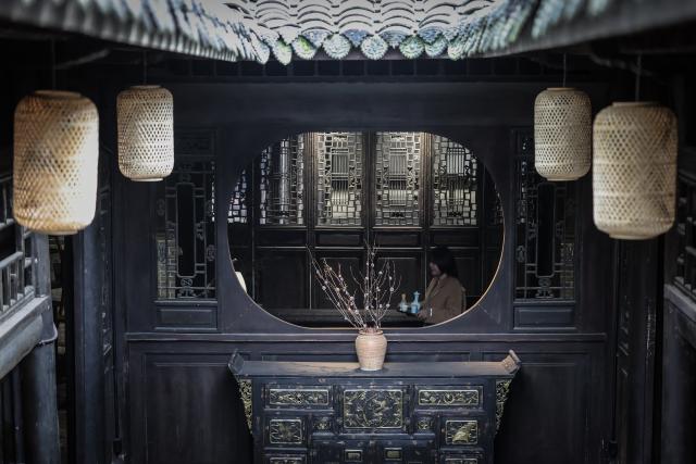 (251219) -- GUANGYUAN, Dec. 19, 2025 (Xinhua) -- Yang Mo, a teahouse owner, works in a teahouse in Zhaohua ancient town in Zhaohua District of Guangyuan City, southwest China's Sichuan Province, Dec. 13, 2025. Zhaohua ancient town, located in Guangyuan City of southwest China's Sichuan Province, sits at the confluence of the Bailong River, the Jialing River, and the Qingjiang River. As a well-preserved ancient town, it carries a history of over 2,300 years.
    However, due to old infrastructure and unplanned construction, the ancient town once fell into disorder with residents living in the town having to undergo various difficulties. In order to refresh the ancient town, since 2012, Zhaohua District has launched a project to preserve the villages as a whole. While improving the village environment, the preservation project brings along local rural tourism, allowing the ancient town to be revitalized through preservation. (Xinhua/Pan Yulong)