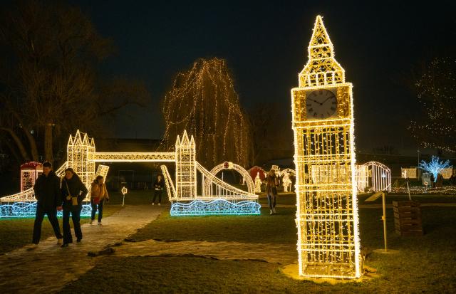 (251219) -- PRAGUE, Dec. 19, 2025 (Xinhua) -- People visit the Story of Lights themed park in Prague, the Czech Republic, Dec. 19, 2025. An Europe-themed light park illuminates the banks of the Vltava River in Prague, offering visitors an immersive journey of architecture and light. (Photo by Dana Kesnerova/Xinhua)