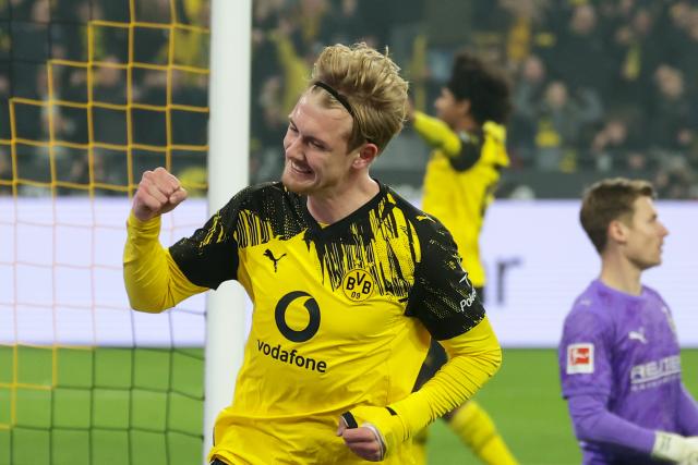 (251220) -- DORTMUND, Dec. 20, 2025 (Xinhua) -- Julian Brandt (front) of Borussia Dortmund celebrates scoring during the German first division Bundesliga football match between Borussia Dortmund and Borussia Moenchengladbach in Dortmund, Germany, Dec. 19, 2025. (Photo by Joachim Bywaletz/Xinhua)