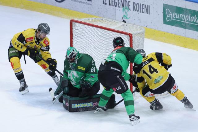 (251220) -- LJUBLJANA, Dec. 20, 2025 (Xinhua) -- Lukas Horak (2nd L), goalkeeper of Olimpija Ljubljana, saves the puck during the 2025/26 Win2day Ice Hockey League match between Olimpija LJubljana and HC Falkensteiner Pustertal in Ljubljana, Slovenia, Dec. 19, 2025. (Photo by Zeljko Stevanic/Xinhua)