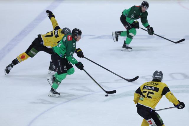 (251220) -- LJUBLJANA, Dec. 20, 2025 (Xinhua) -- Jan Drozg (2nd L) of Olimpija Ljubljana controls the puck during the 2025/26 Win2day Ice Hockey League match between Olimpija LJubljana and HC Falkensteiner Pustertal in Ljubljana, Slovenia, Dec. 19, 2025. (Photo by Zeljko Stevanic/Xinhua)