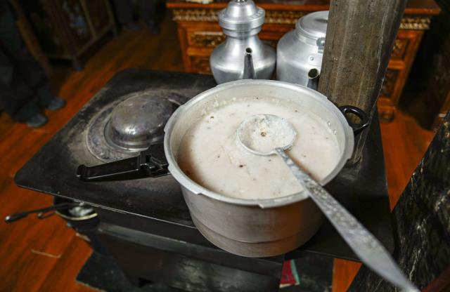 (251220) -- BURANG, Dec. 20, 2025 (Xinhua) -- This photo taken on Dec. 18, 2025 shows "Gutu" cooked at Jamyang Drolma's home in Khorchak Village, Burang County of Ngari Prefecture, southwest China's Xizang Autonomous Region.
  Two days ahead of the Tibetan New Year is the traditional "Gutu Eve" for families to have a feast of "gutu", a traditional soup dish made of flour, at home. "Gu" in Tibetan means nine, which is a lucky number. "Tu" means "pasta." Nine different fillings like wool, charcoal and chili are placed inside the dough drops, and each of these fillings has a meaning. While in Burang, "Gutu" is a sort of porridge with nine ingredients and also a distinctive dish on the dinner table of the "Gutu Eve."
   In Khorchak Village of Burang County, Jamyang Drolma's family is bustling with New Year preparations at home. A pot of "Gutu" steams on the stove, while the "chema," a two-tier rectangular wooden box containing roasted barley and fried wheat grain, is placed to pray for harvest in the next year. This year, the family rejoiced over a bumper harvest of highland barley and peas. "Life is getting better and better, and our New Year celebrations are becoming more lively each year," Jamyang Drolma said with a smile. (Xinhua/Tenzin Nyida)