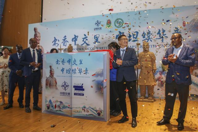(251220) -- DAR ES SALAAM, Dec. 20, 2025 (Xinhua) -- Guests unveil the event "China Bookshelf" in Dar es Salaam, Tanzania, Dec. 19, 2025. China Communications Construction Company (CCCC) Tanzania branch on Friday donated 300 books to Tanzania's University of Dar es Salaam, cementing cultural and educational exchanges between the two countries.
   TO GO WITH "Chinese company donates 300 books to Tanzania's University of Dar es Salaam" (Xinhua/Emmanuel Herman)