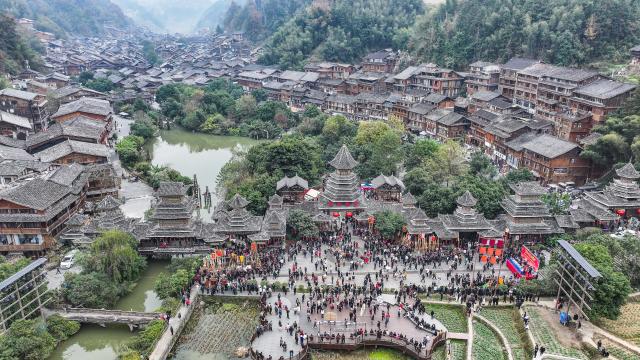 (251220) -- LIPING, Dec. 20, 2025 (Xinhua) -- An aerial drone photo taken on Dec. 20, 2025 shows tourists and people of Dong ethnic group celebrating the Dong New Year at Zhaoxing Dong village of Liping County, Qiandongnan Miao and Dong Autonomous Prefecture, southwest China's Guizhou Province. Dong New Year, a traditional festival for harvest and gathering, was enlisted as one of China's national intangible cultural heritages in 2011. Various activities were held in Liping County over the weekend. (Xinhua/Tao Liang)