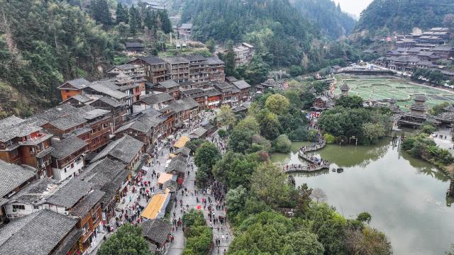 (251220) -- LIPING, Dec. 20, 2025 (Xinhua) -- An aerial drone photo taken on Dec. 20, 2025 shows a performance team parading during an event in celebration of Dong New Year at Zhaoxing Dong village of Liping County, Qiandongnan Miao and Dong Autonomous Prefecture, southwest China's Guizhou Province. Dong New Year, a traditional festival for harvest and gathering, was enlisted as one of China's national intangible cultural heritages in 2011. Various activities were held in Liping County over the weekend. (Xinhua/Tao Liang)