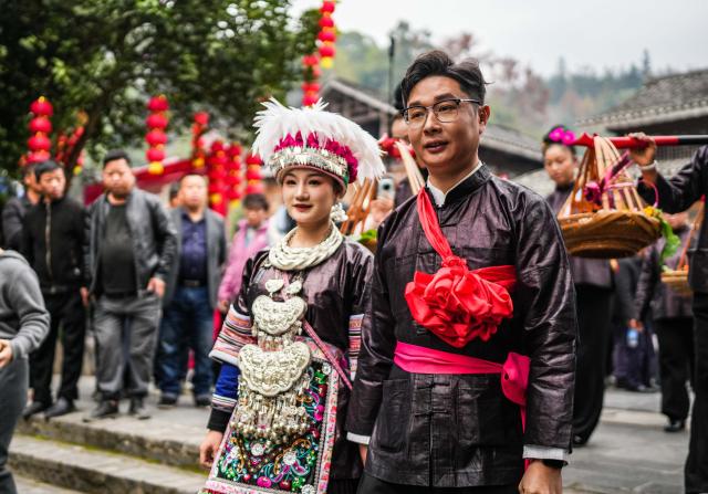 (251220) -- LIPING, Dec. 20, 2025 (Xinhua) -- A performance team parades during an event in celebration of Dong New Year at Zhaoxing Dong village of Liping County, Qiandongnan Miao and Dong Autonomous Prefecture, southwest China's Guizhou Province, Dec. 20, 2025. Dong New Year, a traditional festival for harvest and gathering, was enlisted as one of China's national intangible cultural heritages in 2011. Various activities were held in Liping County over the weekend. (Xinhua/Tao Liang)