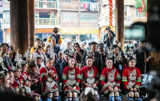 (251220) -- LIPING, Dec. 20, 2025 (Xinhua) -- People sing the grand song of the Dong ethnic group at a drum tower during an event in celebration of Dong New Year at Zhaoxing Dong village of Liping County, Qiandongnan Miao and Dong Autonomous Prefecture, southwest China's Guizhou Province, Dec. 20, 2025. Dong New Year, a traditional festival for harvest and gathering, was enlisted as one of China's national intangible cultural heritages in 2011. Various activities were held in Liping County over the weekend. (Xinhua/Tao Liang)