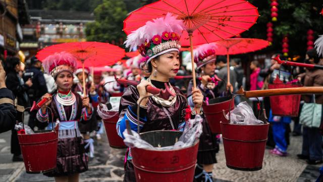 (251220) -- LIPING, Dec. 20, 2025 (Xinhua) -- A performance team parades during an event in celebration of Dong New Year at Zhaoxing Dong village of Liping County, Qiandongnan Miao and Dong Autonomous Prefecture, southwest China's Guizhou Province, Dec. 20, 2025. Dong New Year, a traditional festival for harvest and gathering, was enlisted as one of China's national intangible cultural heritages in 2011. Various activities were held in Liping County over the weekend. (Xinhua/Tao Liang)