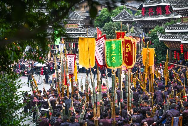 (251220) -- LIPING, Dec. 20, 2025 (Xinhua) -- People of Dong ethnic group play Lusheng, a traditional reed-pipe wind instrument, during an event in celebration of the Dong New Year at Zhaoxing Dong village of Liping County, Qiandongnan Miao and Dong Autonomous Prefecture, southwest China's Guizhou Province, Dec. 20, 2025. Dong New Year, a traditional festival for harvest and gathering, was enlisted as one of China's national intangible cultural heritages in 2011. Various activities were held in Liping County over the weekend. (Xinhua/Yang Wenbin)