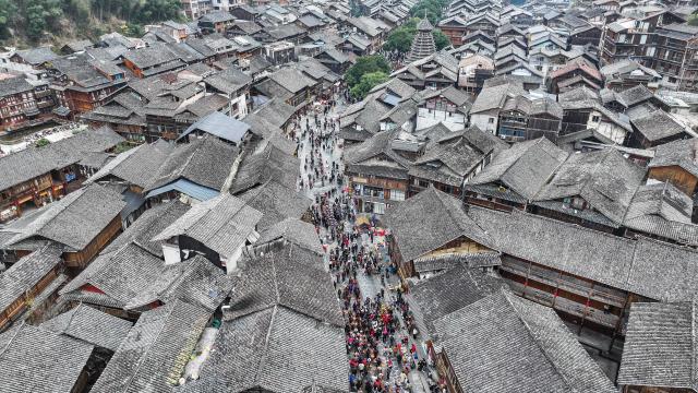 (251220) -- LIPING, Dec. 20, 2025 (Xinhua) -- An aerial drone photo taken on Dec. 20, 2025 shows a performance team parading during an event in celebration of Dong New Year at Zhaoxing Dong village of Liping County, Qiandongnan Miao and Dong Autonomous Prefecture, southwest China's Guizhou Province. Dong New Year, a traditional festival for harvest and gathering, was enlisted as one of China's national intangible cultural heritages in 2011. Various activities were held in Liping County over the weekend. (Xinhua/Tao Liang)