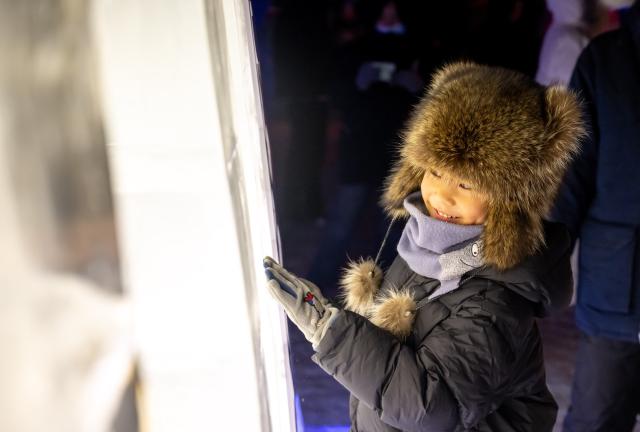 (251220) -- MANZHOULI, Dec. 20, 2025 (Xinhua) -- A child plays at an ice and snow theme park in Manzhouli, north China's Inner Mongolia Autonomous Region, Dec. 20, 2025. The 22nd China-Russia-Mongolia international ice and snow festival opened here on Saturday.
   The theme park created for the festival covers an area of 128,000 square meters. (Xinhua/Lian Zhen)