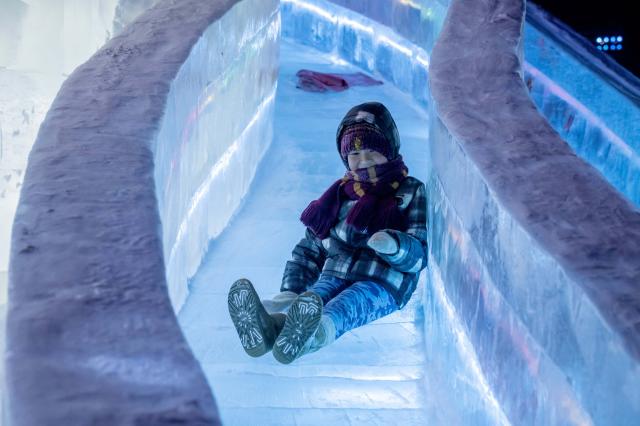 (251220) -- MANZHOULI, Dec. 20, 2025 (Xinhua) -- A child plays at an ice and snow theme park in Manzhouli, north China's Inner Mongolia Autonomous Region, Dec. 20, 2025. The 22nd China-Russia-Mongolia international ice and snow festival opened here on Saturday.
   The theme park created for the festival covers an area of 128,000 square meters. (Xinhua/Lian Zhen)