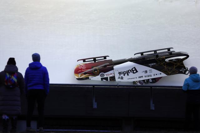 (251221) -- SIGULDA, Dec. 21, 2025 (Xinhua) -- Renars Grantins and Lauris Kaufmanis of Latvia crash during the 2-man bobsleigh heat at the IBSF Bobsleigh and Skeleton World Cup in Sigulda, Latvia, Dec. 20, 2025. (Photo by Edijs Palens/Xinhua)
