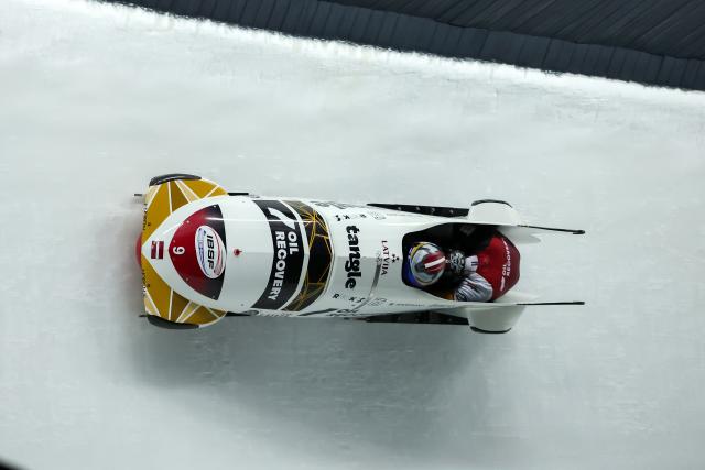 (251221) -- SIGULDA, Dec. 21, 2025 (Xinhua) -- Jekabs Kalenda and Matiss Miknis of Latvia compete during the 2-man bobsleigh heat at the IBSF Bobsleigh and Skeleton World Cup in Sigulda, Latvia, Dec. 20, 2025. (Photo by Edijs Palens/Xinhua)