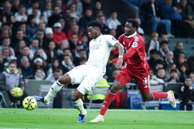 (251221) -- MADRID, Dec. 21, 2025 (Xinhua) -- Real Madrid's Aurelien Tchouameni (L) vies with Sevilla FC's Lucien Agoume during a La Liga football match between Real Madrid and Sevilla FC at Santiago Bernabeu stadium in Madrid, Spain, on Dec. 20, 2025. (Photo by Gustavo Valiente/Xinhua)