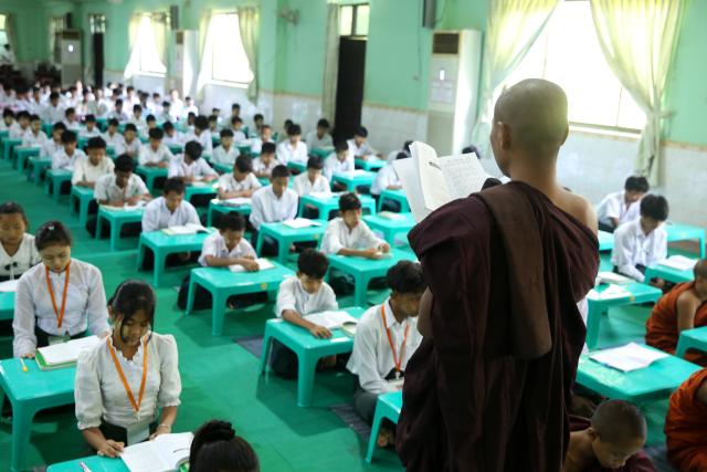 (251221) -- YANGON, Dec. 21, 2025 (Xinhua) -- A Buddhist monk teaches a lesson during a meditation course at a post-primary monastic school in Yangon, Myanmar, Dec. 11, 2025. TO GO WITH "Feature: More than study aid: Meditation takes root as way of life for Myanmar children" (Xinhua/Myo Kyaw Soe)