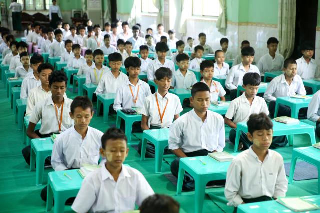 (251221) -- YANGON, Dec. 21, 2025 (Xinhua) -- Students attend a meditation course at a post-primary monastic school in Yangon, Myanmar, Dec. 11, 2025. TO GO WITH "Feature: More than study aid: Meditation takes root as way of life for Myanmar children" (Xinhua/Myo Kyaw Soe)