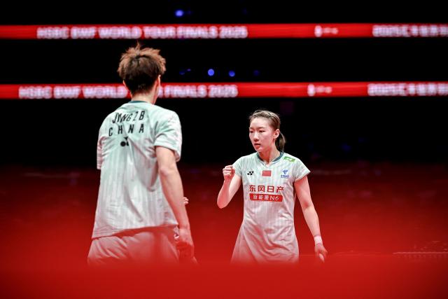 (251221) -- HANGZHOU, Dec. 21, 2025 (Xinhua) -- Jiang Zhenbang (L)/Wei Yaxin celebrate scoring during the mixed doubles final match between Feng Yanzhe/Huang Dongping of China and Jiang Zhenbang/Wei Yaxin of China at BWF World Tour Finals 2025 in Hangzhou, east China's Zhejiang Province, Dec. 21, 2025. (Xinhua/Jiang Han)