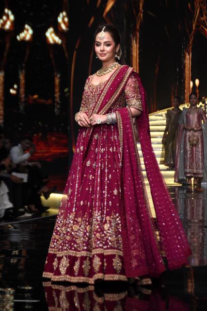 (251221) -- LAHORE, Dec. 21, 2025 (Xinhua) -- A model presents a creation during the Hum Bridal Couture Week fashion show in Lahore, Pakistan on Dec. 20, 2025. (Photo by Sajjad/Xinhua)