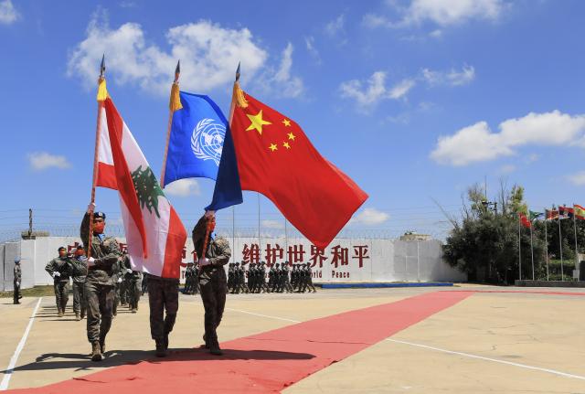 (251221) -- BEIJING, Dec. 21, 2025 (Xinhua) -- Chinese peacekeepers march at a medal parade ceremony in Hanniyah village, southern Lebanon, July 1, 2022. (Xinhua/Liu Zongya)