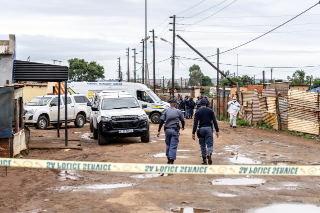 (251221) -- JOHANNESBURG, Dec. 21, 2025 (Xinhua) -- Police officers cordon off the scene of a shooting incident in Bekkersdal, South Africa, on Dec. 21, 2025. At least nine people were killed and 10 others wounded in a shooting in Bekkersdal township near Johannesburg, South Africa's largest city and economic hub, local police said Sunday. (Photo by Shiraaz Mohamed/Xinhua)