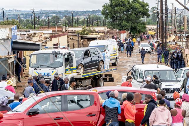 (251221) -- JOHANNESBURG, Dec. 21, 2025 (Xinhua) -- People are seen at the scene of a shooting incident in Bekkersdal, South Africa, on Dec. 21, 2025. At least nine people were killed and 10 others wounded in a shooting in Bekkersdal township near Johannesburg, South Africa's largest city and economic hub, local police said Sunday. (Photo by Shiraaz Mohamed/Xinhua)