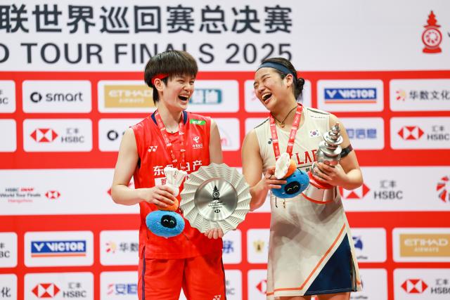 (251221) -- HANGZHOU, Dec. 21, 2025 (Xinhua) -- An Se Young (R) of South Korea and Wang Zhiyi of China pose at the awarding ceremony after their women's singles final at BWF World Tour Finals 2025 in Hangzhou, east China's Zhejiang Province, Dec. 21, 2025. (Xinhua/Jiang Han)