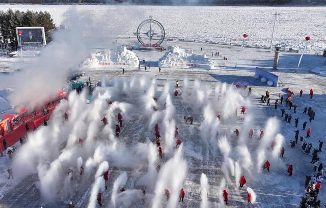 (251221) -- MOHE, Dec. 21, 2025 (Xinhua) -- A drone photo taken on Dec. 21, 2025 shows the "water to ice" performance at a cultural festival on the occasion of the Winter Solstice in Beiji Village of Mohe City, northeast China's Heilongjiang Province. People attended a cultural festival marking the Winter Solstice, the shortest day of the year, here on Sunday. (Photo by Shao Tianli/Xinhua)