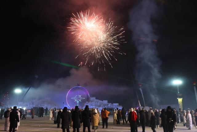 (251221) -- MOHE, Dec. 21, 2025 (Xinhua) -- People watch a firework show at a cultural festival on the occasion of the Winter Solstice in Beiji Village of Mohe City, northeast China's Heilongjiang Province, Dec. 21, 2025. People attended a cultural festival marking the Winter Solstice, the shortest day of the year, here on Sunday. (Photo by Shao Tianli/Xinhua)