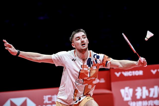 (251221) -- HANGZHOU, Dec. 21, 2025 (Xinhua) -- Christo Popov of France hits a return during the men's singles final against Shi Yuqi of China at BWF World Tour Finals 2025 in Hangzhou, east China's Zhejiang Province, Dec. 21, 2025. (Xinhua/Jiang Han)