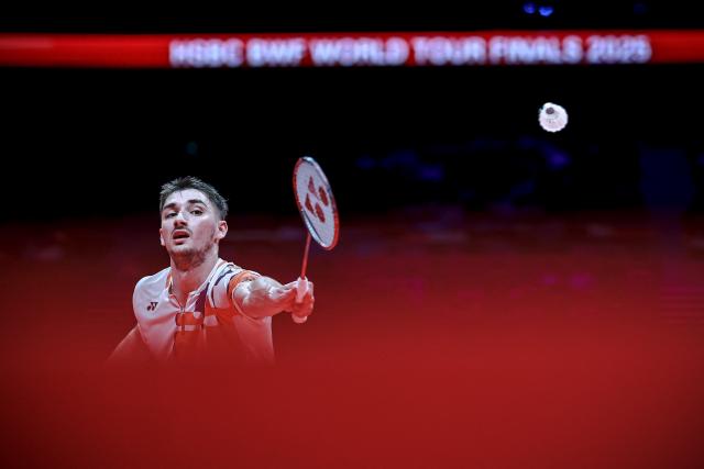 (251221) -- HANGZHOU, Dec. 21, 2025 (Xinhua) -- Christo Popov of France hits a return during the men's singles final against Shi Yuqi of China at BWF World Tour Finals 2025 in Hangzhou, east China's Zhejiang Province, Dec. 21, 2025. (Xinhua/Jiang Han)
