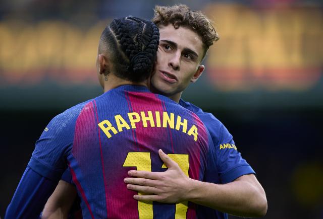 (251222) -- VILA-REAL, Dec. 22, 2025 (Xinhua) -- Raphinha (L) of Barcelona celebrates a goal with Fermin Lopez during the La Liga football match between Villarreal and Barcelona in Vila-Real, Spain, Dec. 21, 2025. (Str/Xinhua)