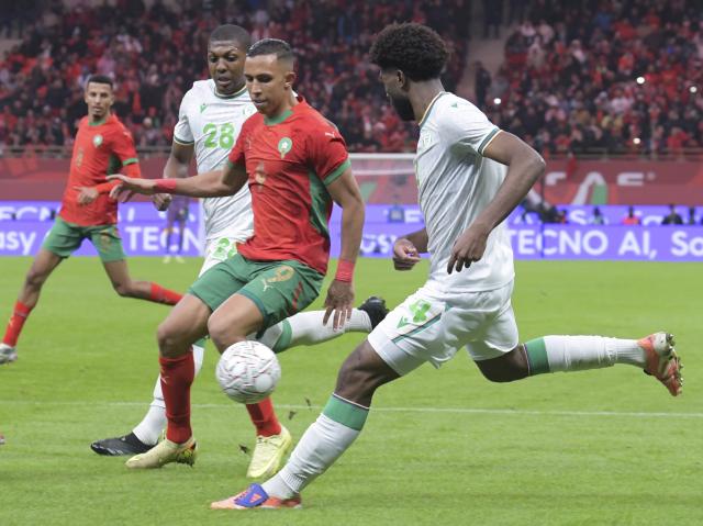 (251222) -- RABAT, Dec. 22, 2025 (Xinhua) -- Soufiane Rahimi (2nd R) of Morocco vies with Kenan Toubibou (1st R) of Comoros during the opening match of the Africa Cup of Nations 2025 between Morocco and Comoros in Rabat, Morocco, Dec. 21, 2025. (Photo by Aissa/Xinhua)
