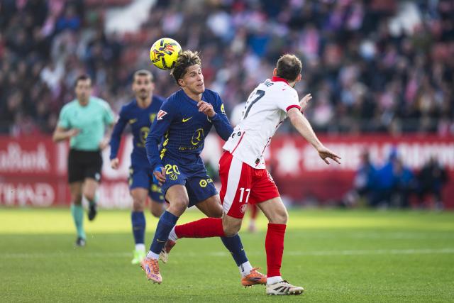 (251222) -- GIRONA, Dec. 22, 2025 (Xinhua) -- Giuliano Simeone (L) of Atletico de Madrid vies with Daley Blind of Girona FC during the La Liga football match between Girona FC and Atletico de Madrid in Montilivi Stadium, Girona, Spain, on Dec. 21, 2025. (Photo by Joan Gosa/Xinhua)